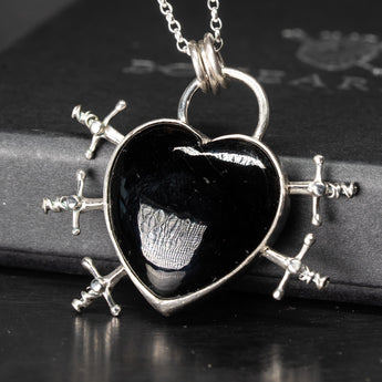 heart shaped black onyx one-of-a-kind necklace with 5 swords going through the sides in silver