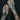 Tattooed hands holding Bonearrow jewellery in deep red garnet and silver tones
