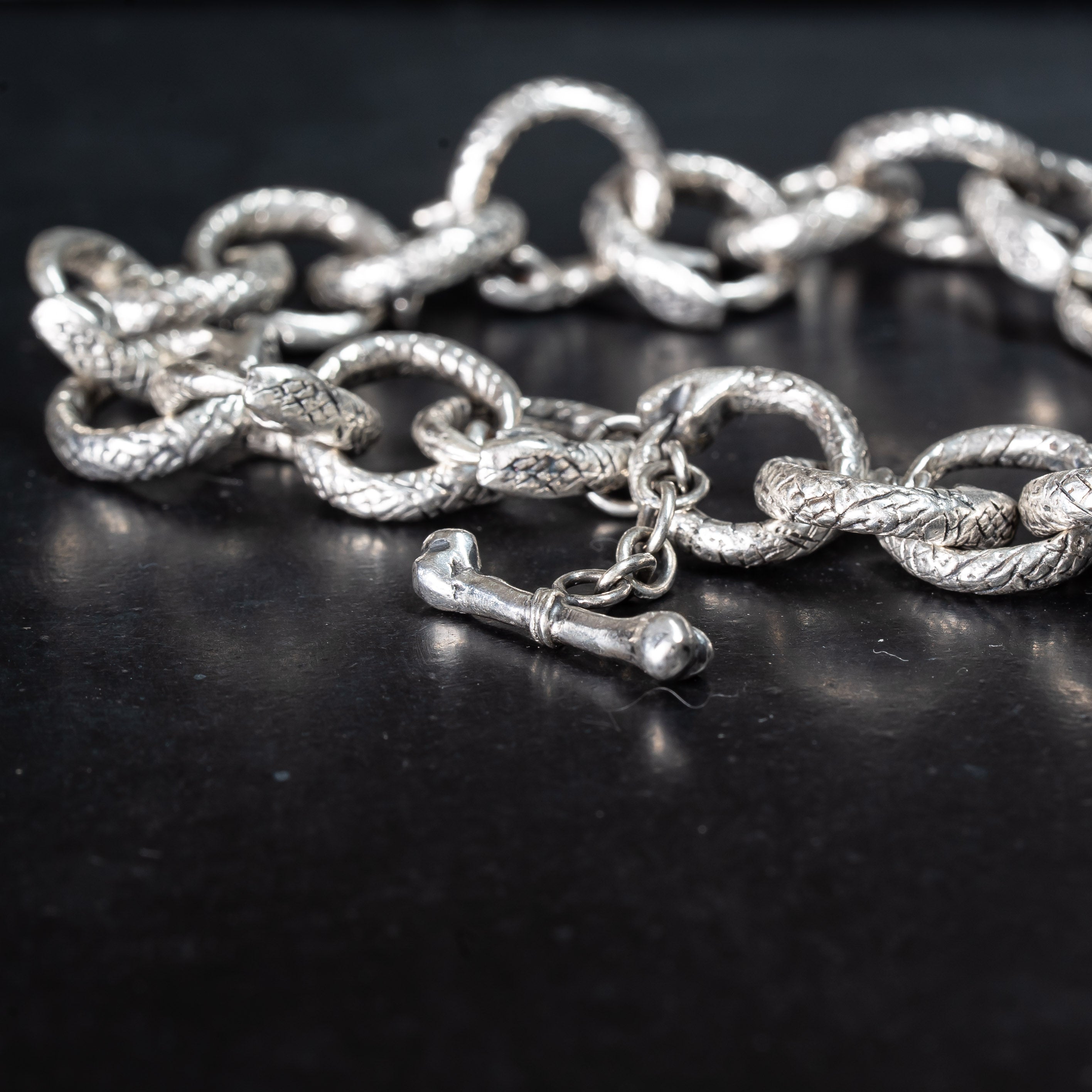 Snake bracelet close up detail. Handmade silver jewellery.