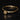Side view of gold skull motif stacking ring