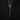 A handmade, oxidised sterling silver coffin nail charm hanging on a chain by a silver snake bail, displayed on a dark black background.