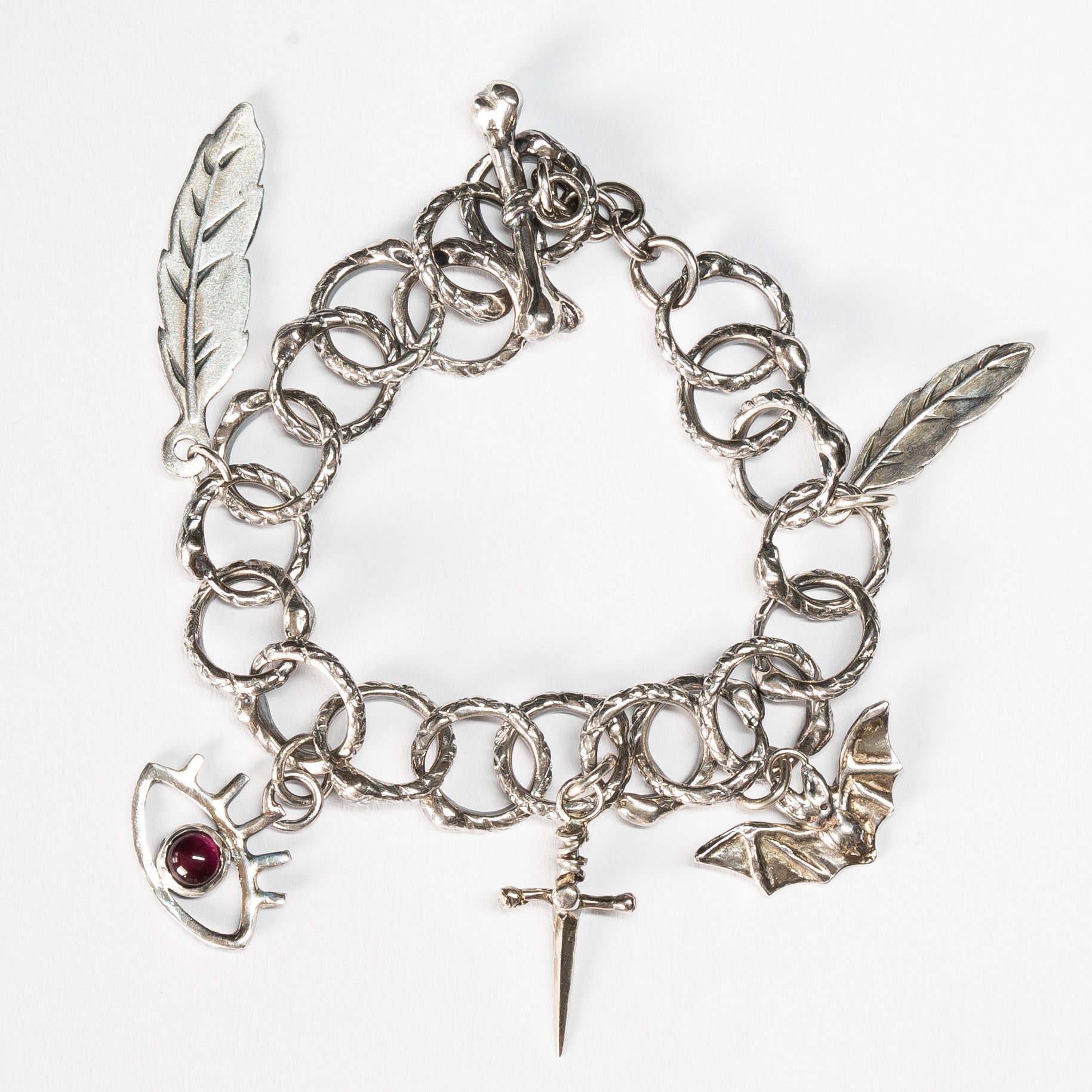 alternative gothic style sterling silver charm bracelet on a white background