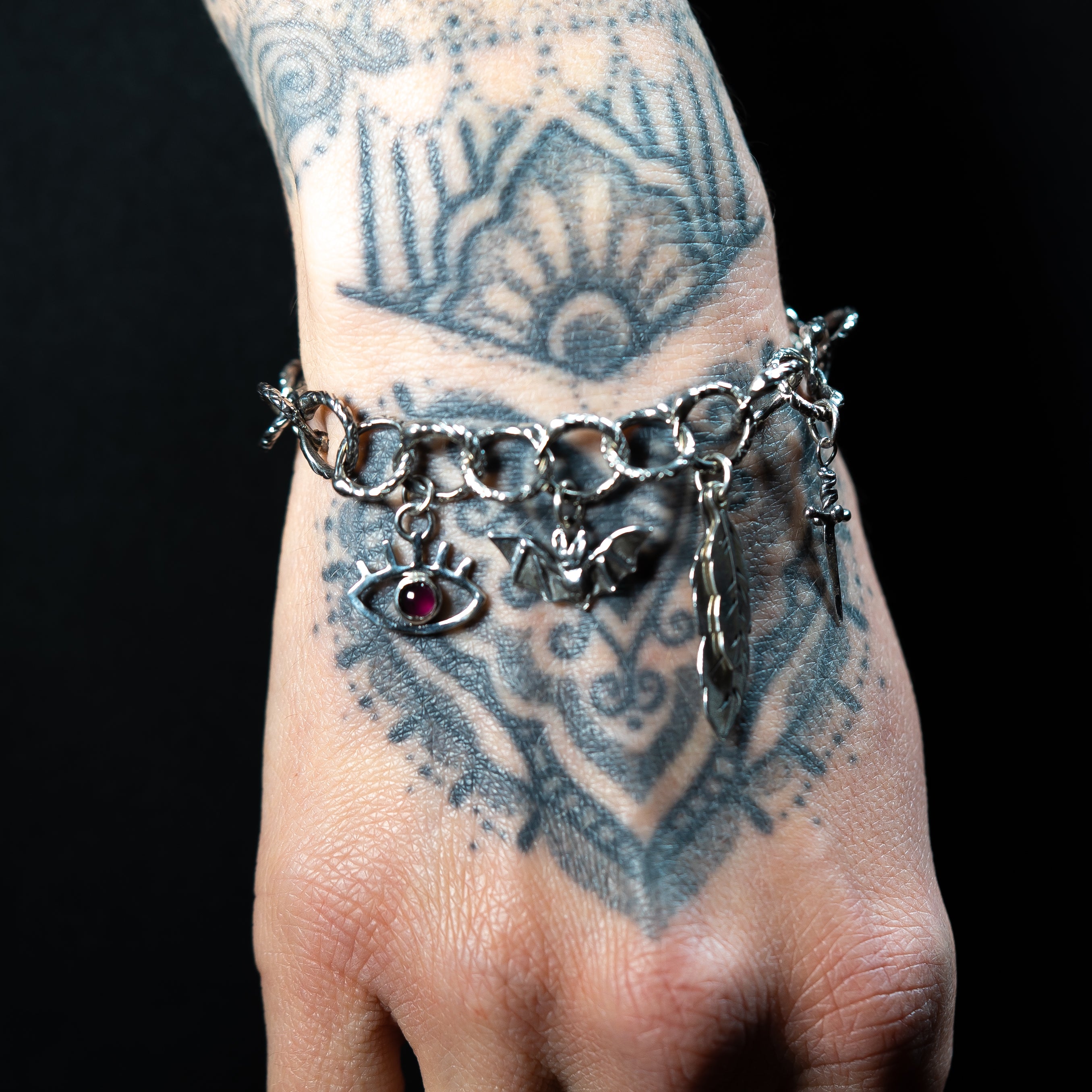 gothic jewellery handmade charm bracelet on a tattoed wrist