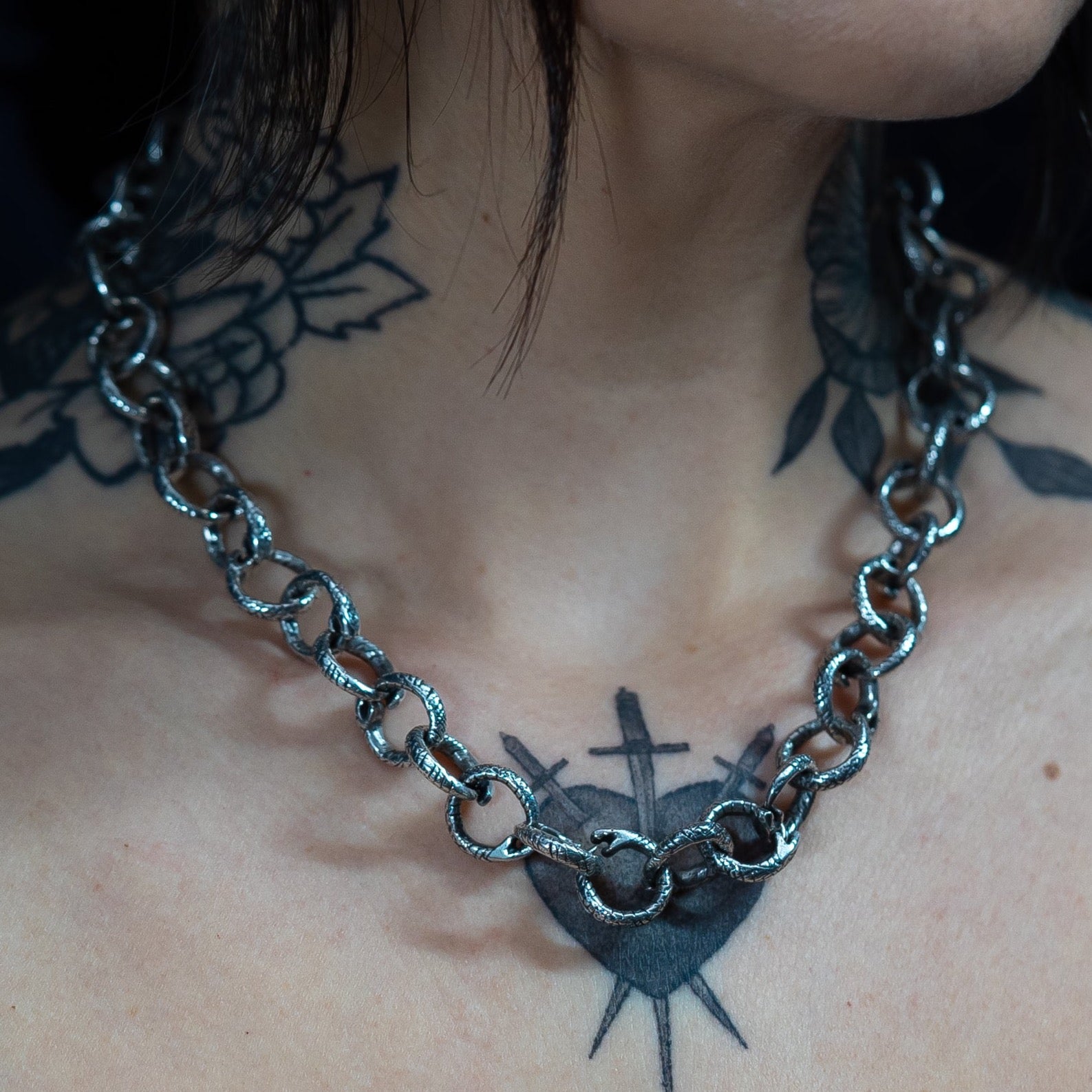 handmade chain snake link necklace in sterling silver on a gothic aesthetic style female model with neck tattoos