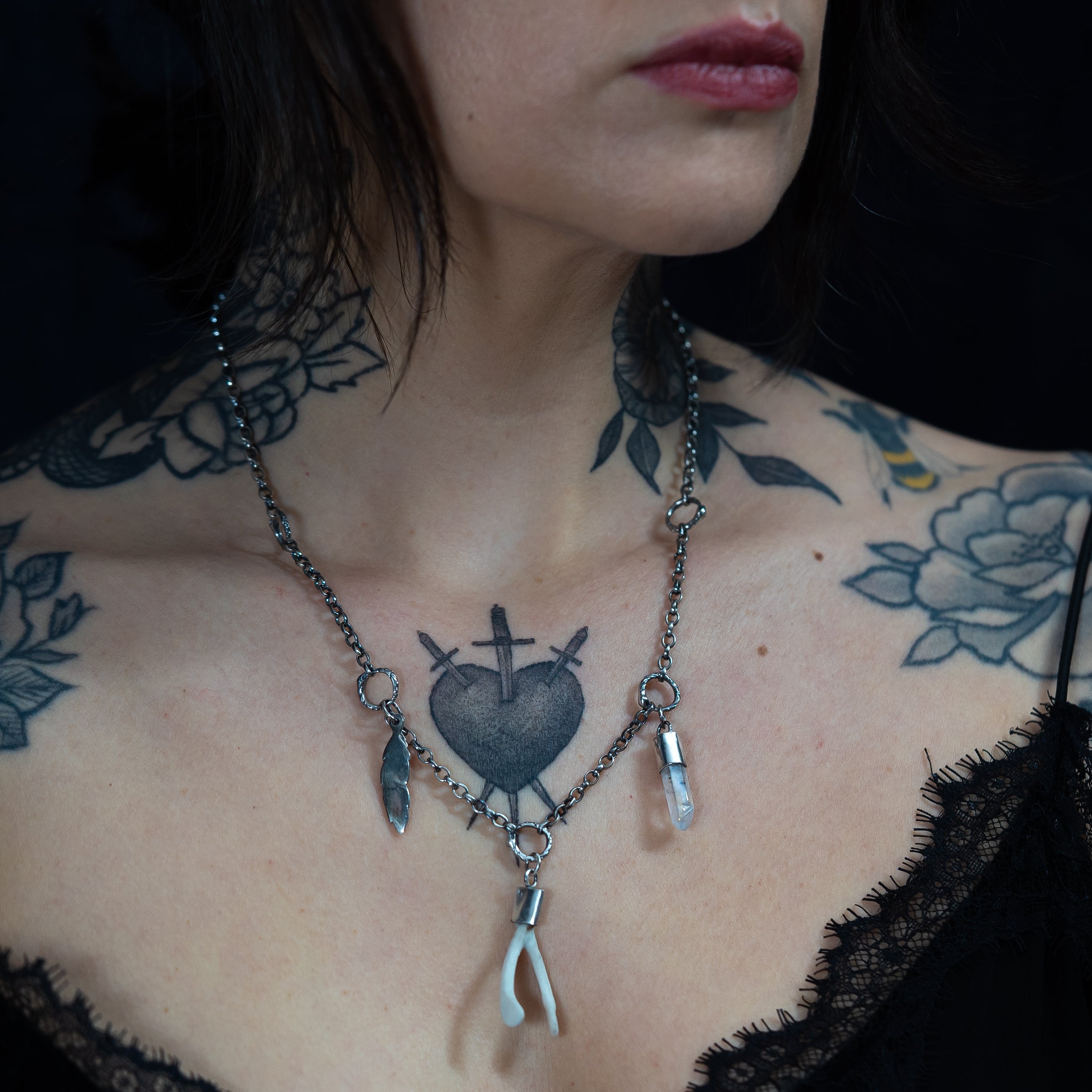 Alternative model with  floral tattoos wearing handmade one of a kind lucky charm chain 