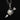 Silver pendant with heart and arrow design on a black background