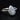 Silver ring with a teardrop-shaped gemstone on a black background