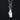 Silver charm with a coffin-shaped serpentine stone with a silver belladonna flower on a black background