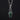 Silver charm with a coffin-shaped serpentine stone with a silver belladonna flower on a black background