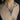 Necklace with a pendant on a person's neck with tattoos visible.