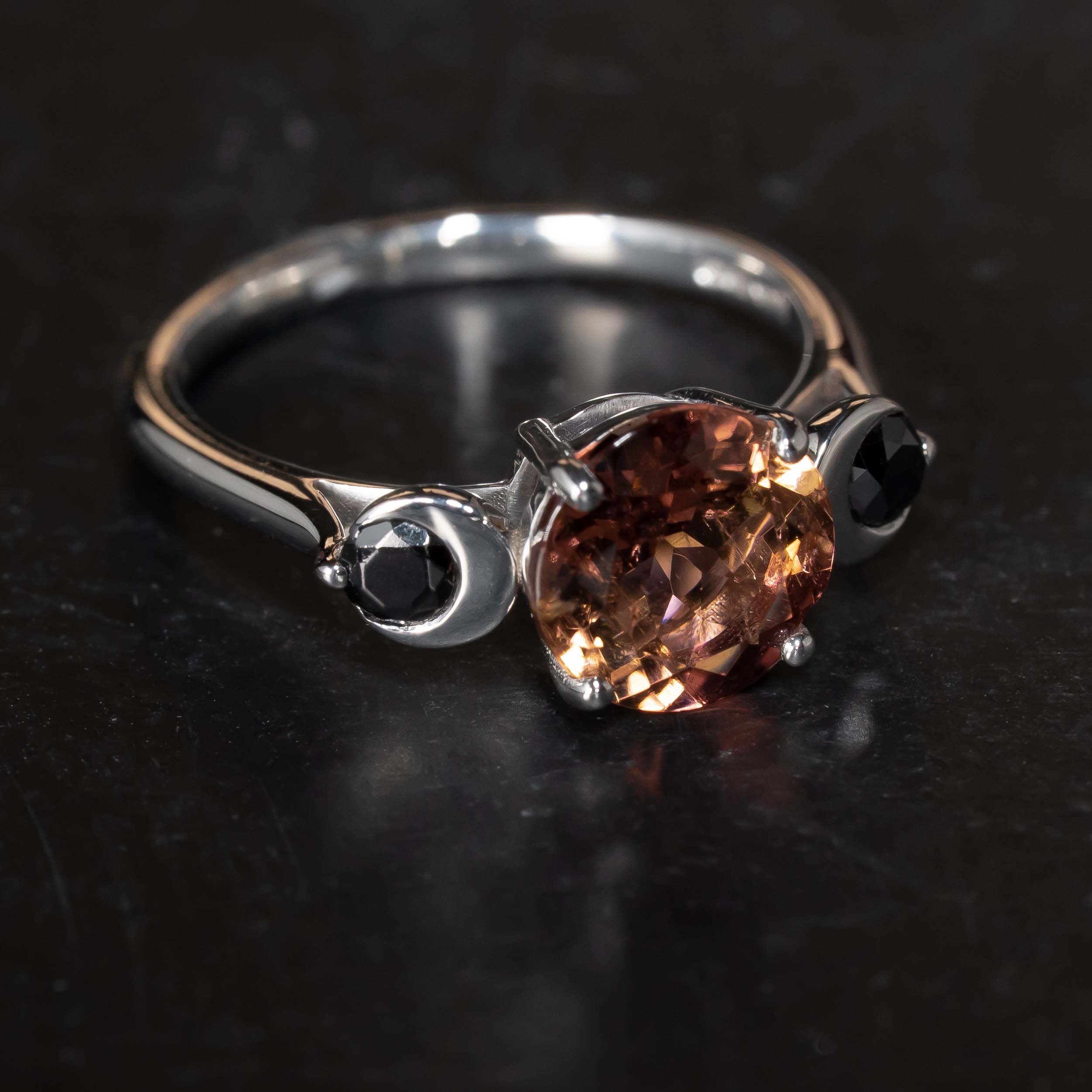 side view of alternative style ring with moon detail and Pink Tourmaline & Black Diamond