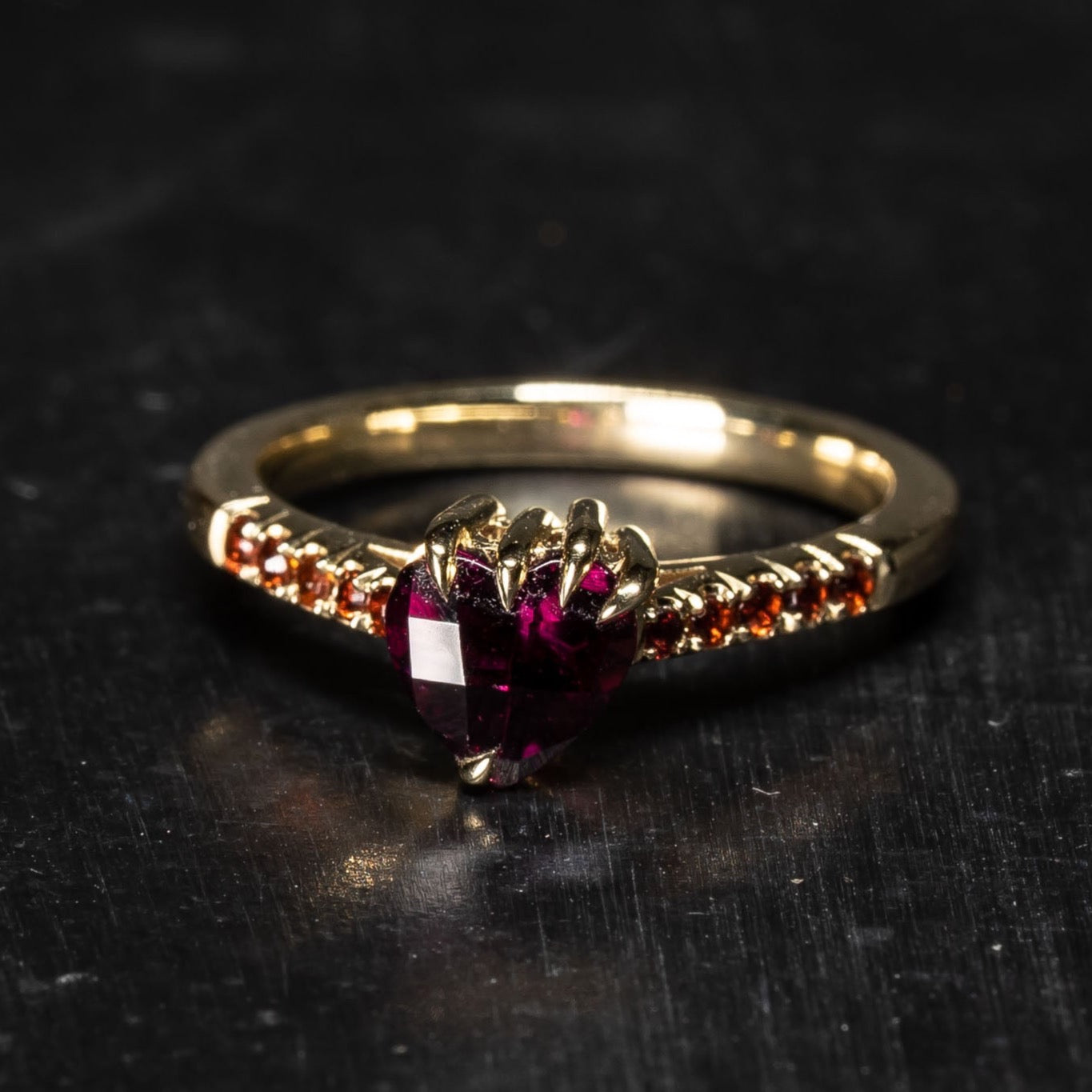 Darkly beloved collection ring with heart shaped garnet