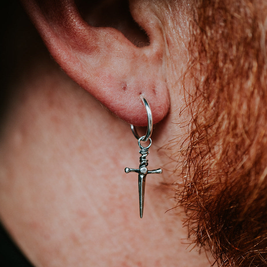 man wearing a small hoop dagger earring