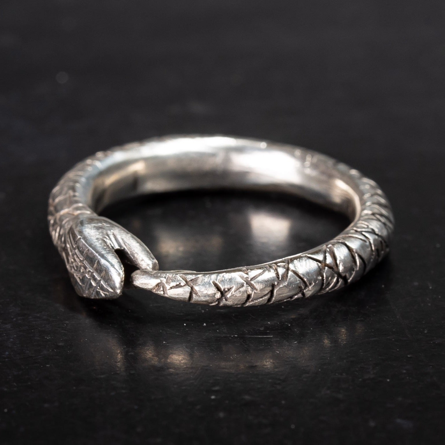 mens sterling silver snake ring, ouroboros snake eating its own tail on black background