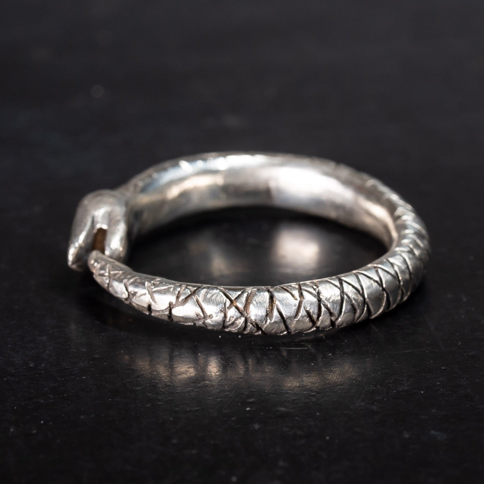 Bonearrow sterling silver snake ring, ouroboros snake eating its own tail on black background