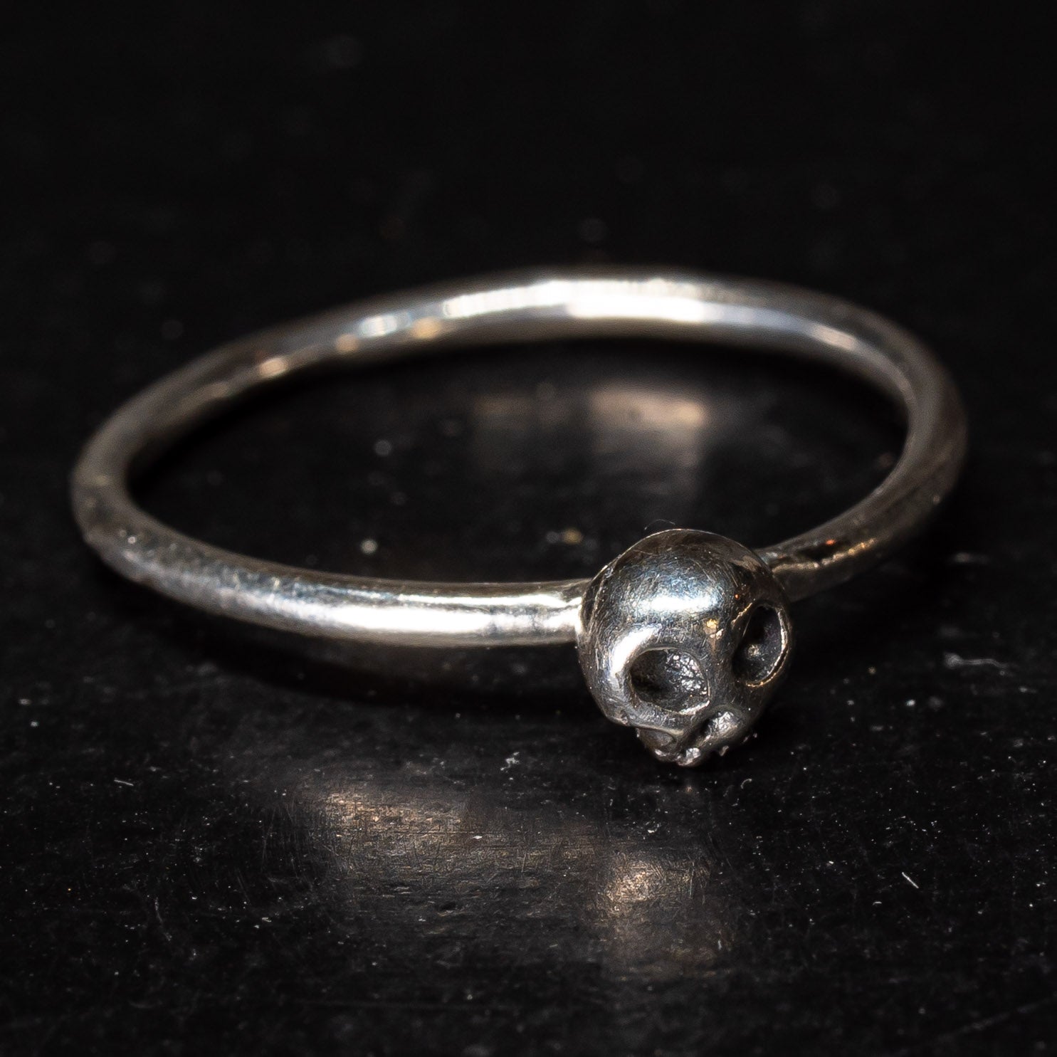 Gothic style staking ring with small skull