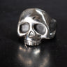 Sterling silver skull ring with no bottom jaw on black background